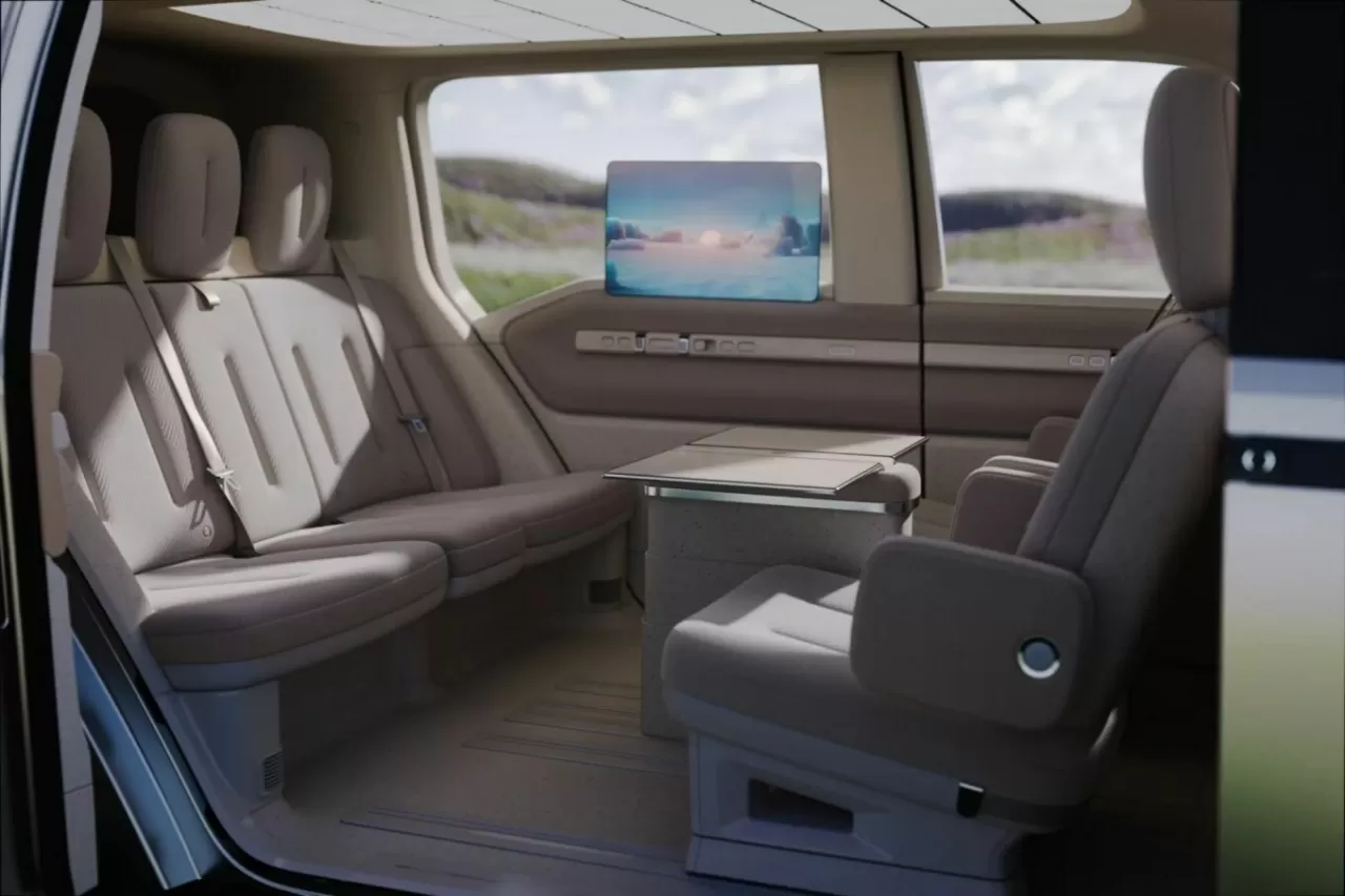 The robotaxi features rotatable front seats, foldable tables, and large screens to create a homey ambiance. img#4