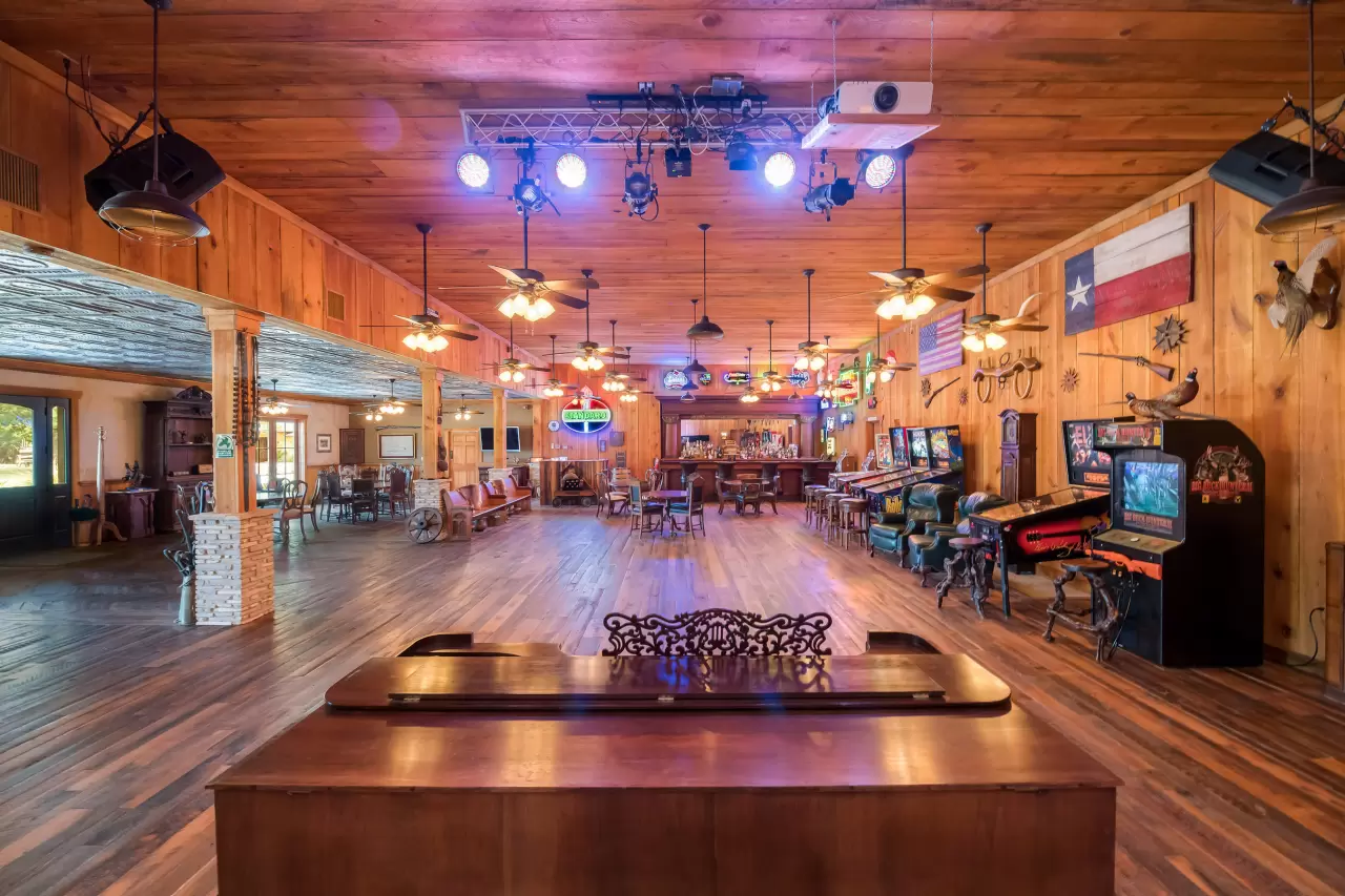 The property also includes an impressive “party barn” that also functions as a conference center. The custom-built structure includes an imported wet bar, professional-caliber “DJ booth” and performance stage img#3