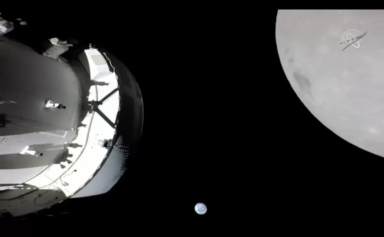 On Nov. 21, 2022, a camera on Orion's solar array wing captured this view of the spacecraft, the Earth and the Moon. Orion was making its outbound powered flyby of the Moon as part of the Artemis I mission, img#1