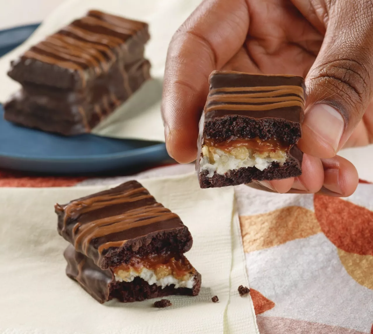 Hostess® Kazbars™ combine layers of soft chocolate cake, cream, candy crunch and melt-in-your-mouth caramel or smooth chocolate fudge, covered in a rich chocolate-flavored coating and topped with a delicious drizzle. img#1