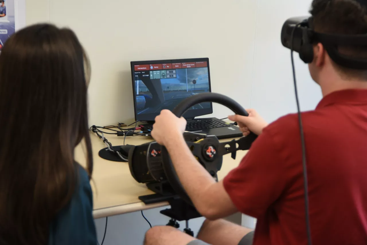 Nicklaus Children's Hospital DRIVE Program behavioral analyst monitors a student's performance during a driving simulation. img#2