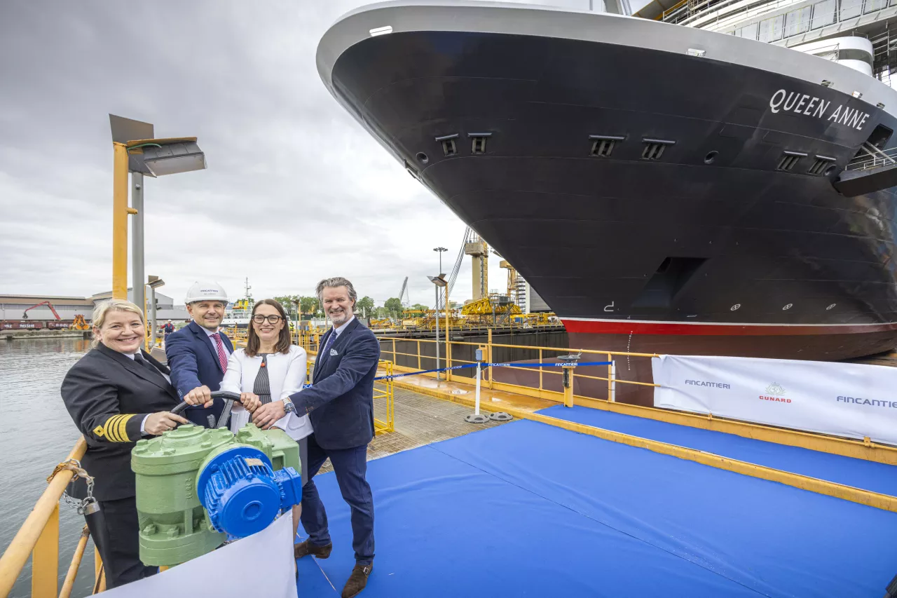 Captain Inger Klein Thorhauge, Marco Lunardi, shipyard Director, Roberta Mundula and Sture Myrmell, Carnival UK President in front of Cunard’s newest ship, Queen Anne, at the Fincantieri Marghera shipyard in Venice, Italy. (Cunard) img#2